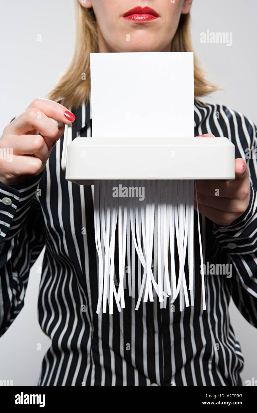 Woman shredding paper Stock Photo