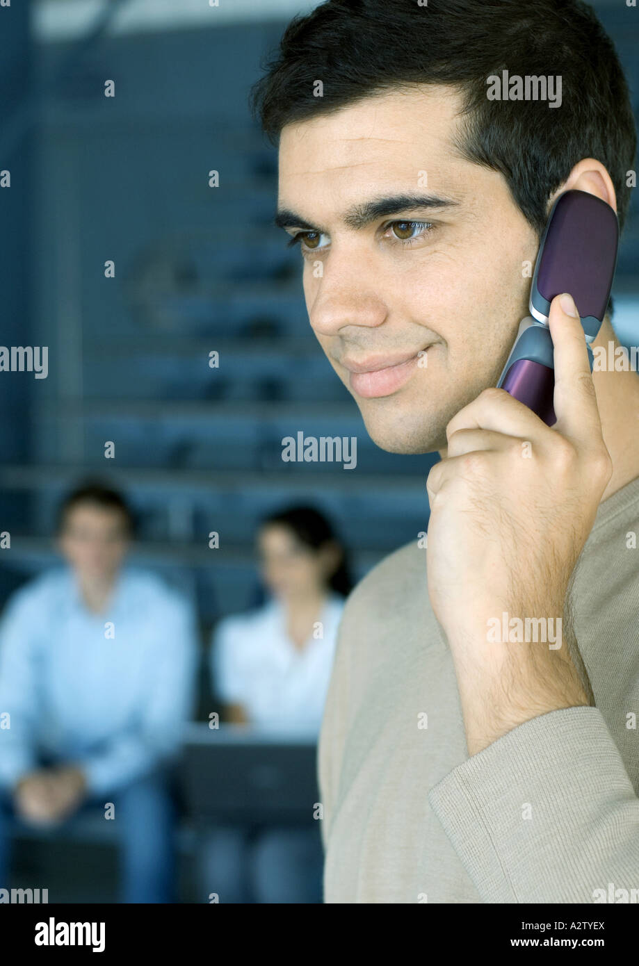 Man using cell phone, smiling Stock Photo - Alamy