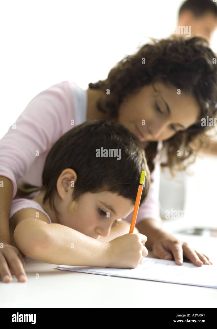 Mother helping child with homework Stock Photo - Alamy