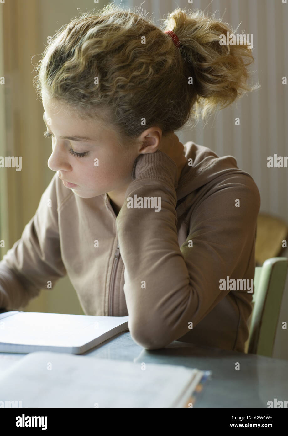 Preteen girl doing homework Stock Photo
