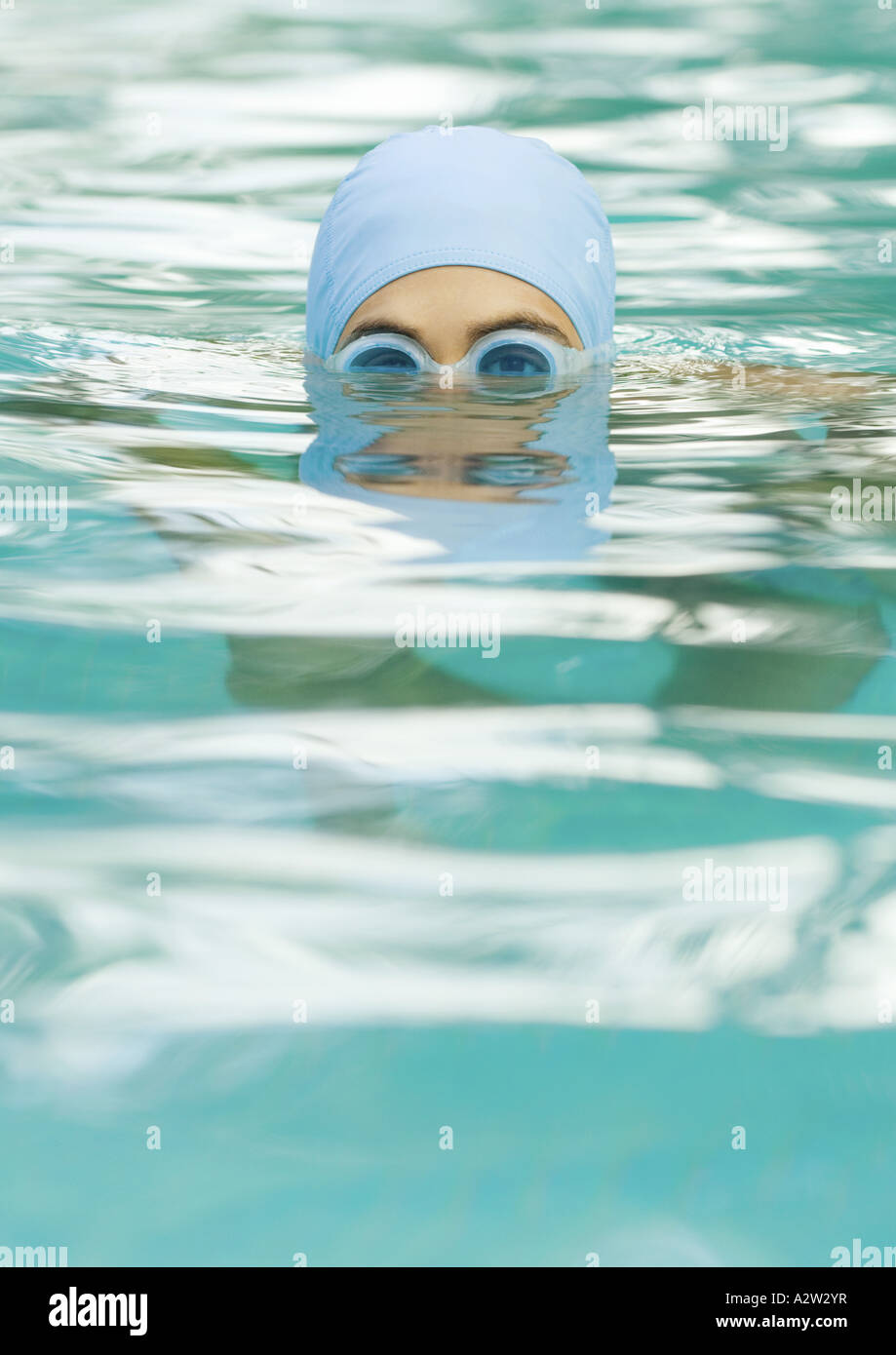 Person in swimming pool wearing bathing cap and goggles Stock Photo Alamy