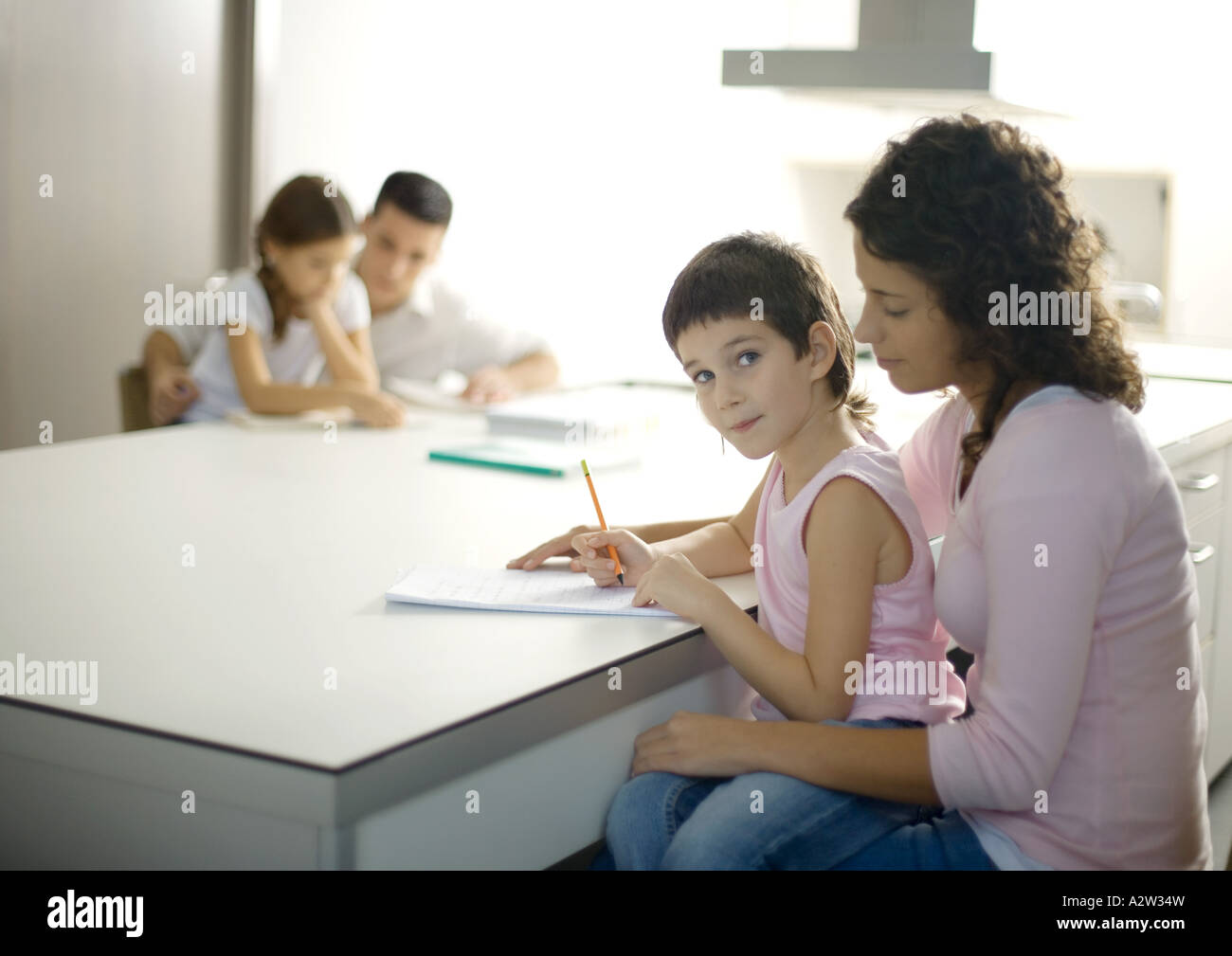 Parents helping children with homework Stock Photo - Alamy