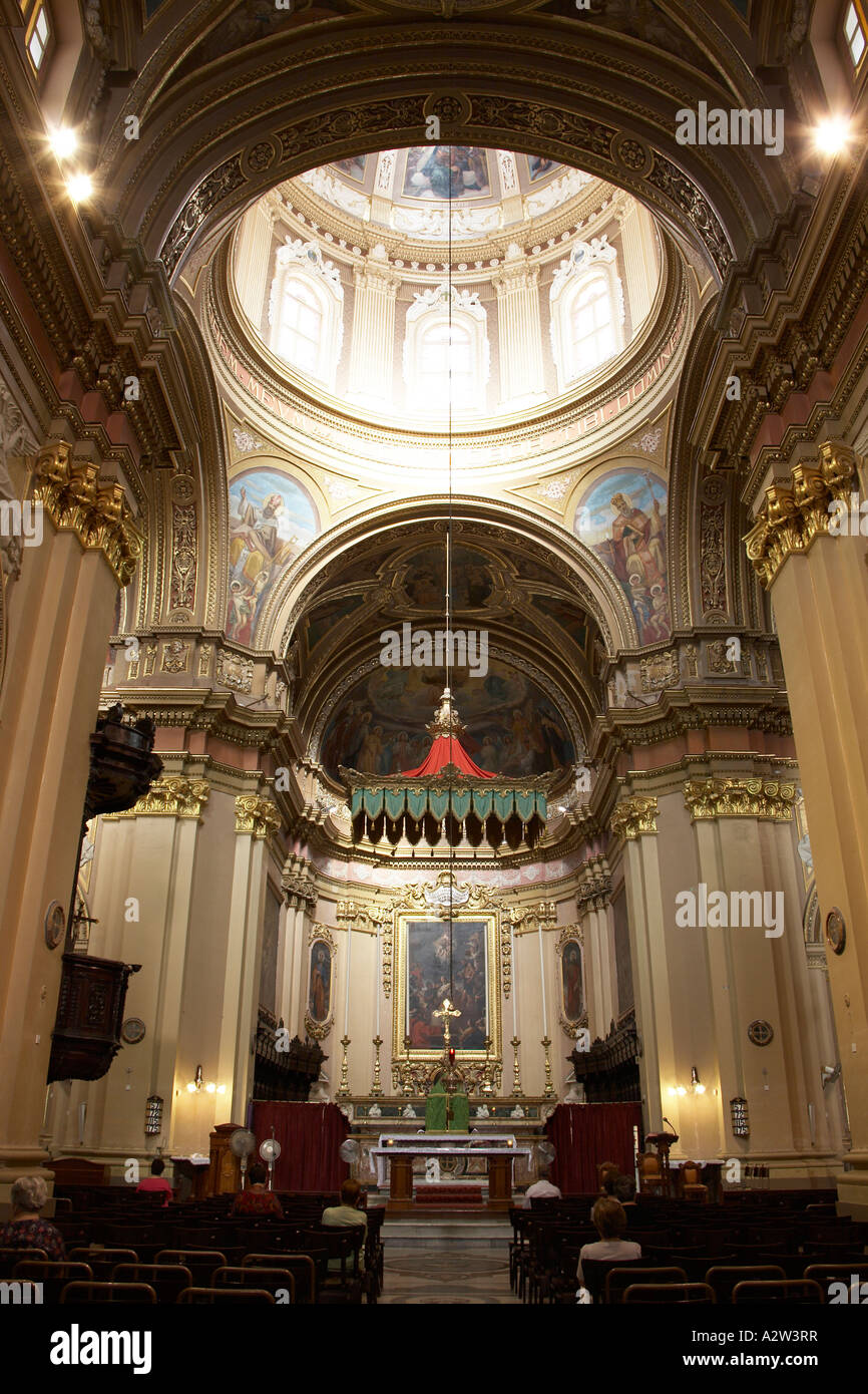 Interior with dome and worshipers of St Catherine s church in Zejtun town on Mediterranean island of Malta Europe EU Stock Photo