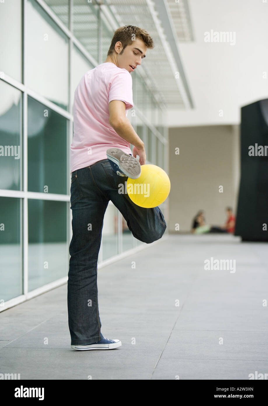 Teen boy playing with ball Stock Photo - Alamy