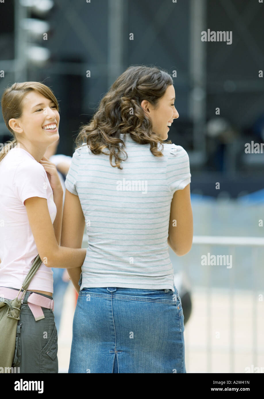 Two teen girls standing outside together, smiling Stock Photo