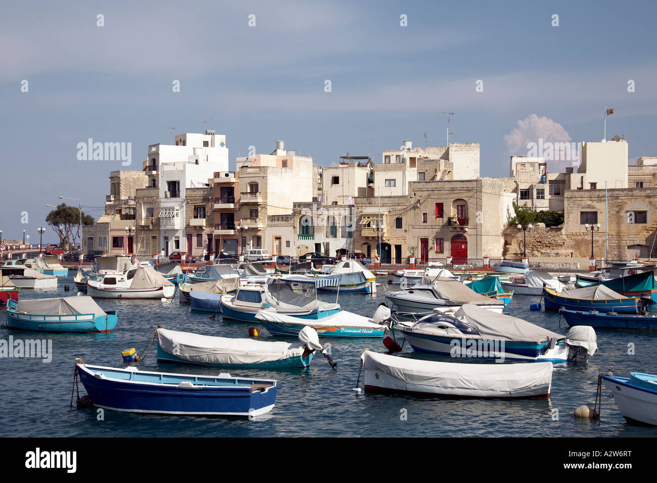 Colourful fishing boats and traditional houses on St Bay