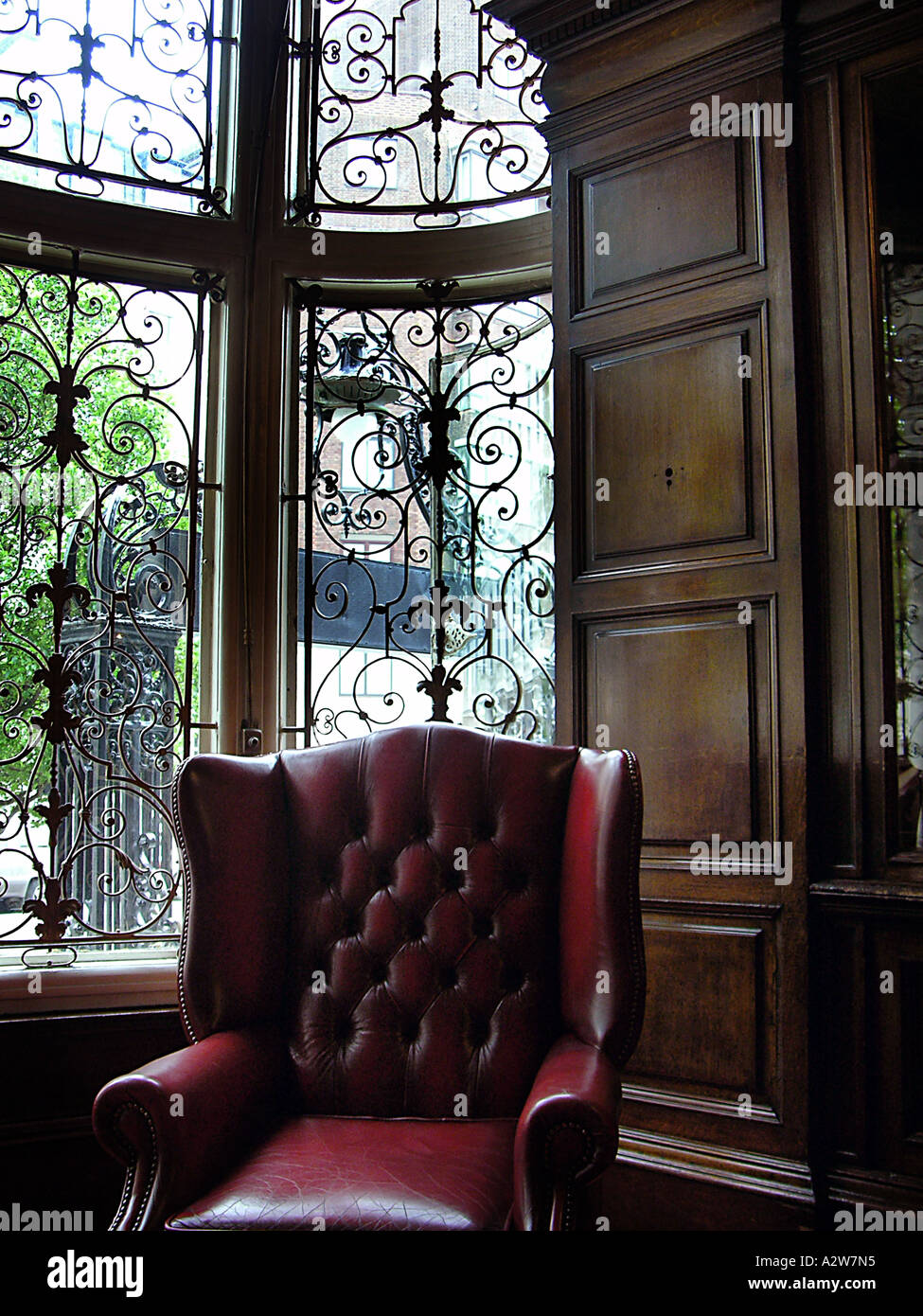 Leather arm chair in a wooden den Stock Photo Alamy