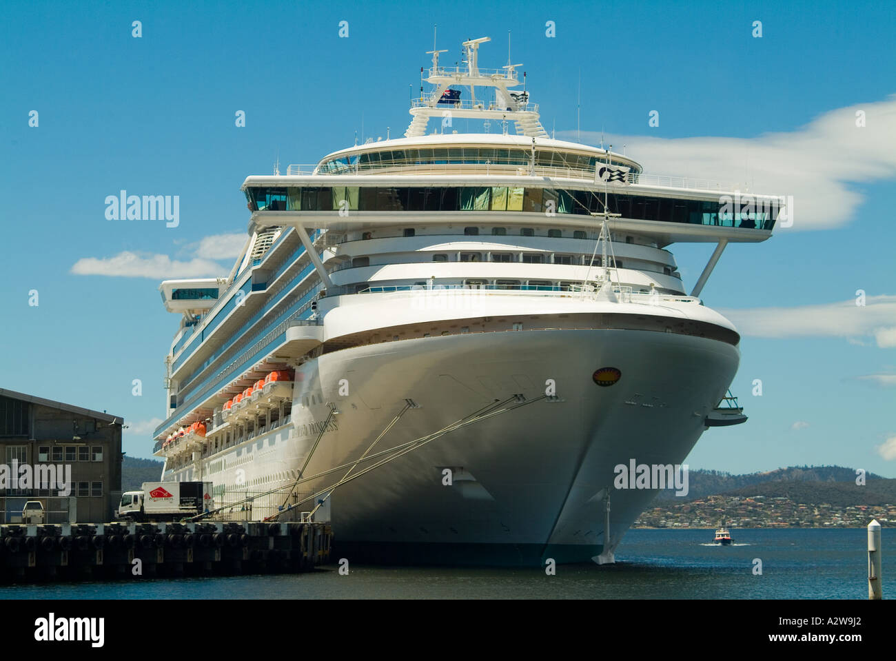 The Diamond Princess world s largest cruise liner moored in Hobart Tasmnia dwarfs the dockside sheds Stock Photo