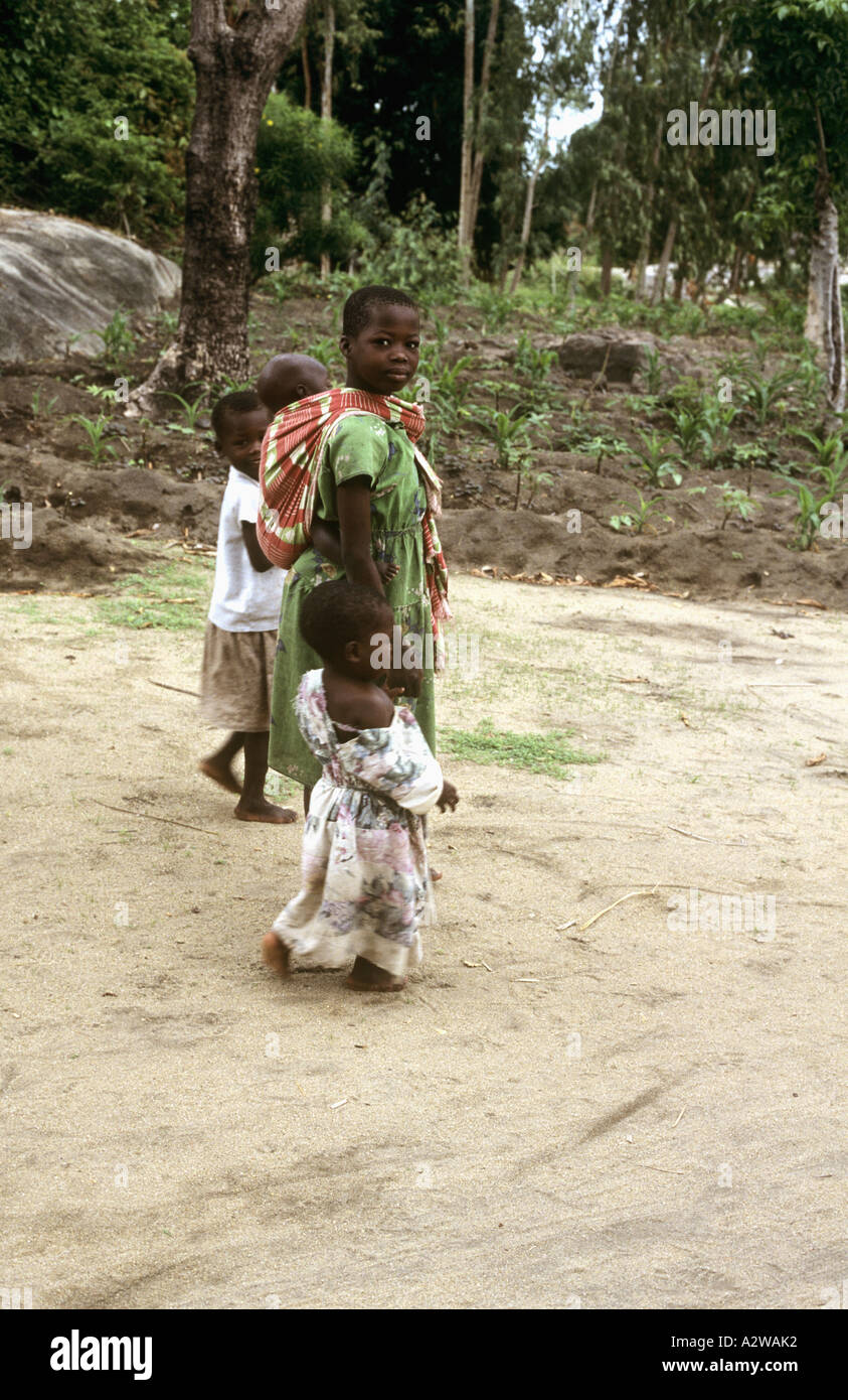 Young girl carrying a baby on her back in Nkhotakota, Lake Malawi, Malawi Stock Photo