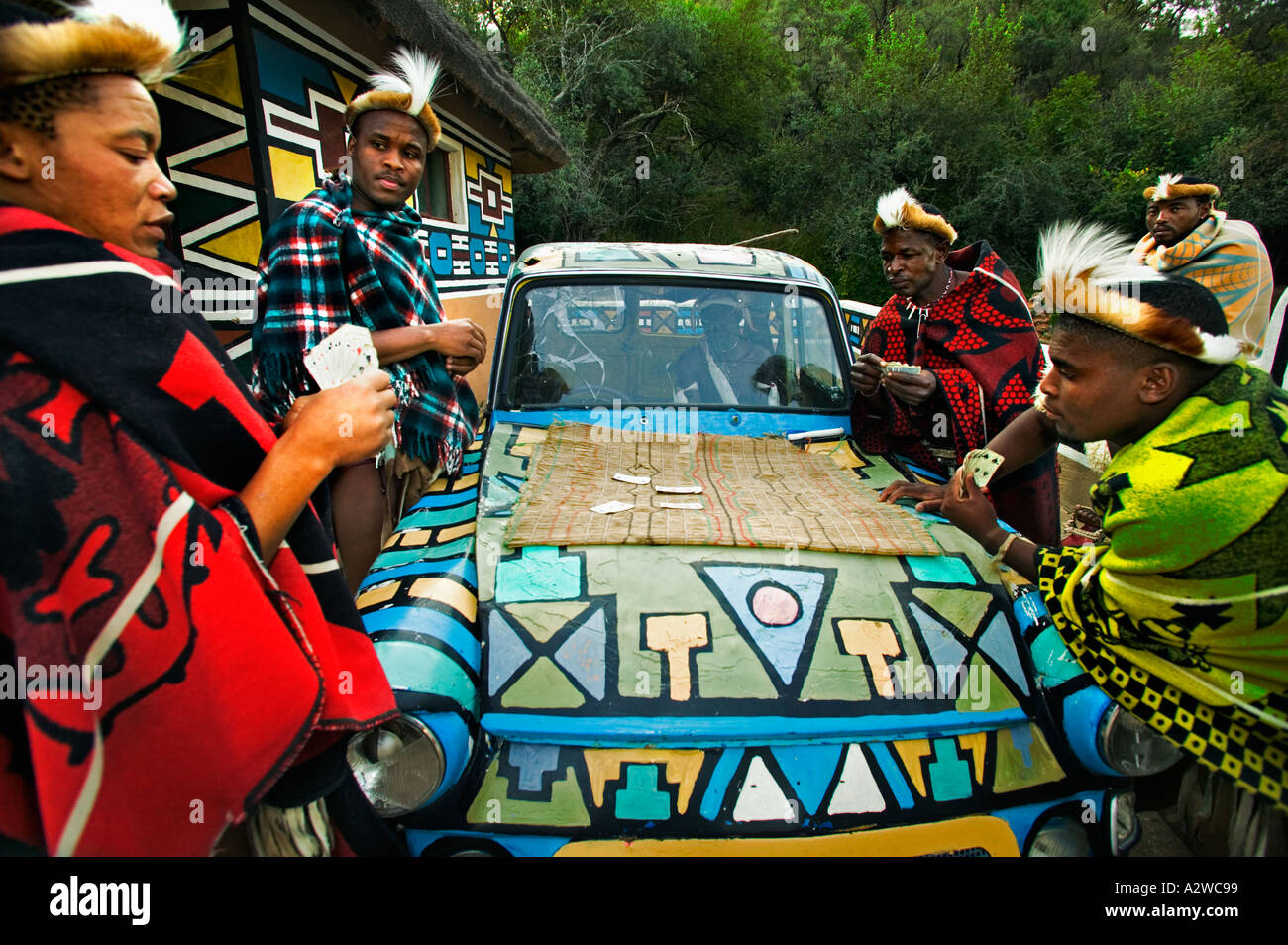 People African men playing cards around an old car Model released Lesedi Cultural Village near Johannesburg South Africa Stock Photo
