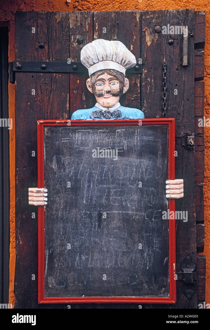 Empty menu board in front of old door to restaurant Stock Photo - Alamy