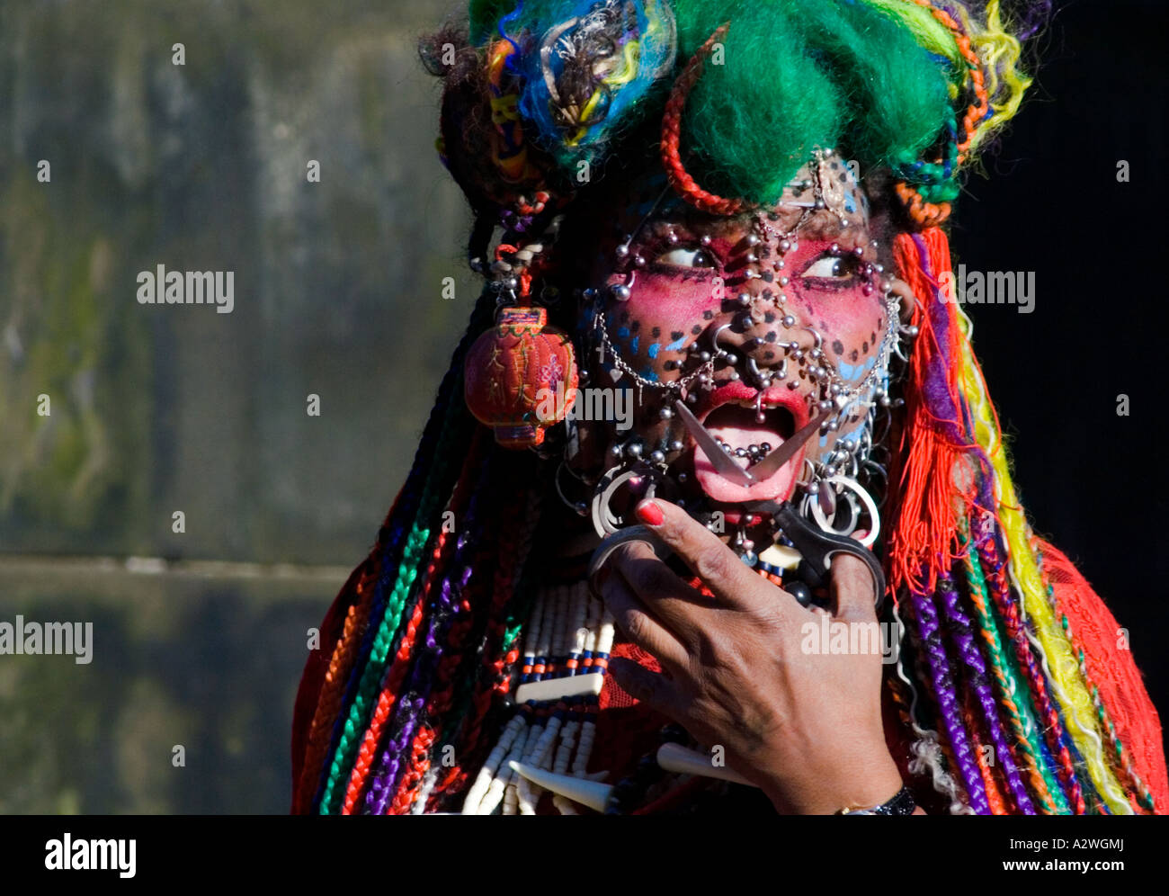 The world's most pierced woman at the Edinburgh festival fringe inserts a pair of scissors through her tongue, Scotland. Stock Photo