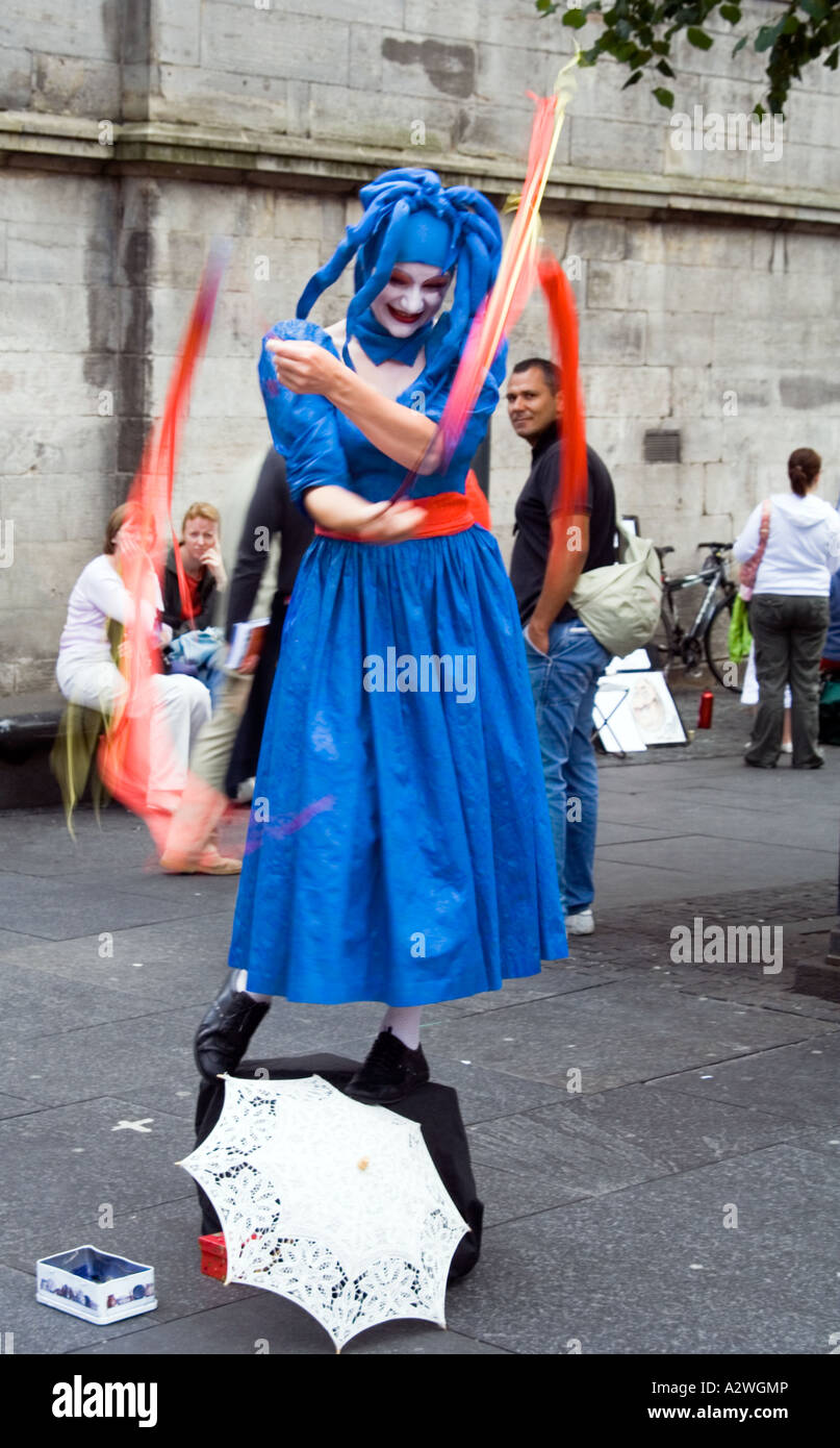 Mime artist swirlling ribbons as part of her act at the Edinburgh festival fringe Royal mile, Scotland. Stock Photo