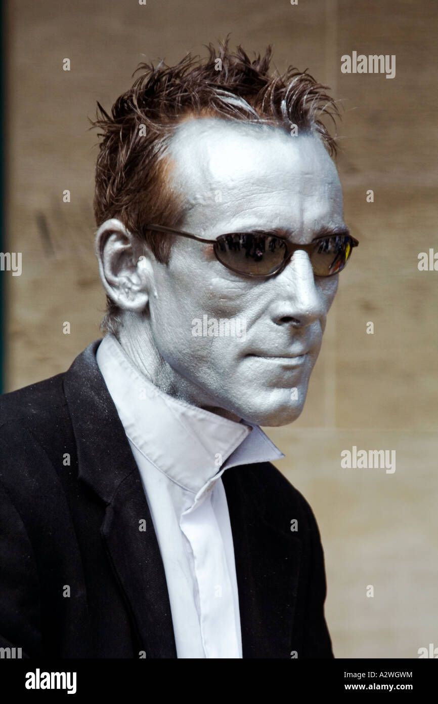 A mime artist with silver face paint and sunglasses at the Edinburgh