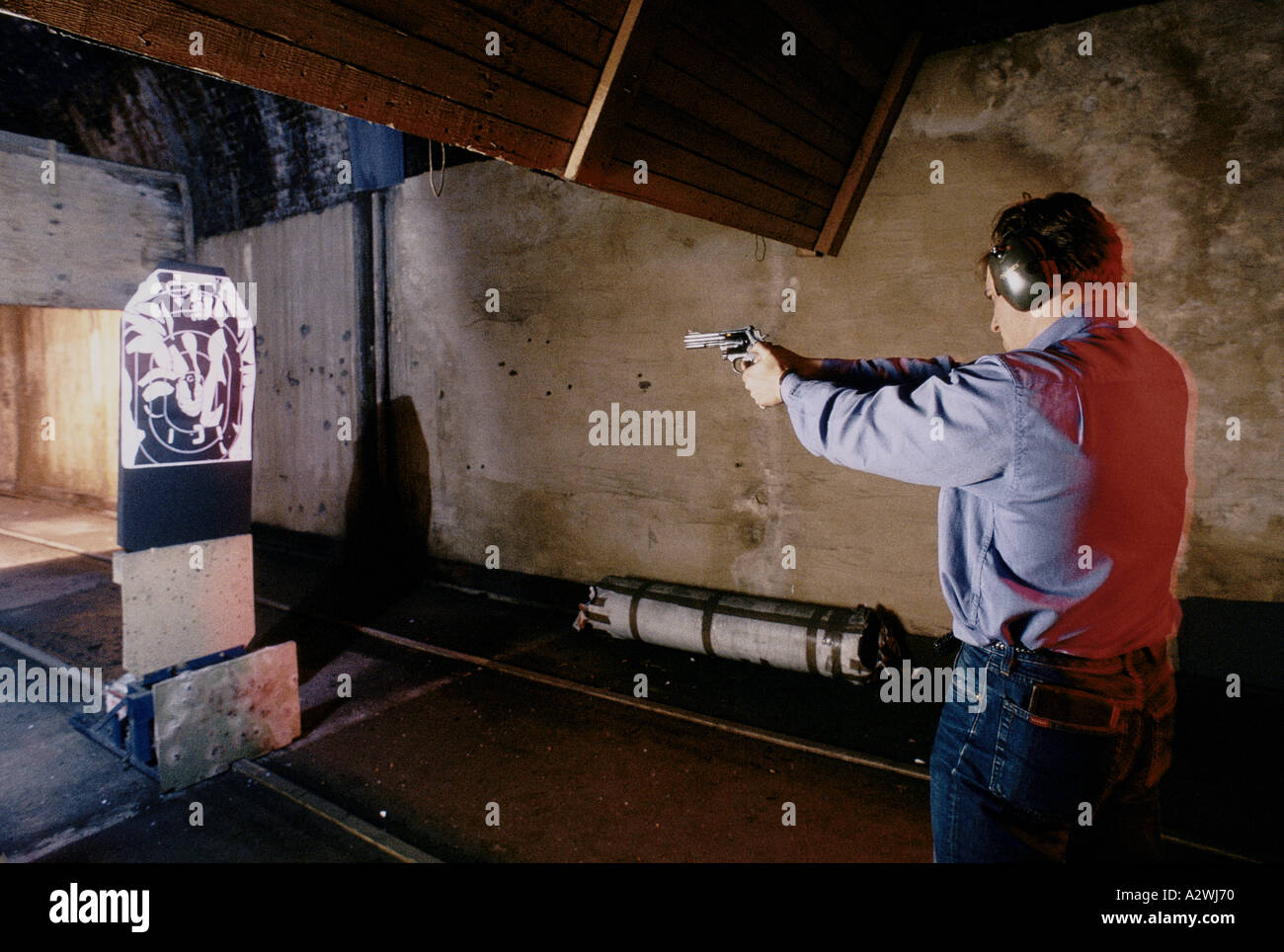 Man shooting full-bore pistol at a registered gun club Stock Photo