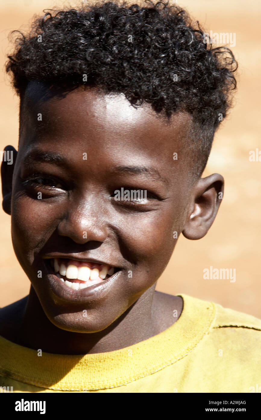 Young boy with curly hair and cheeky smile expression in village near Mendi  western Ethiopia Africa Head face portrait Stock Photo - Alamy