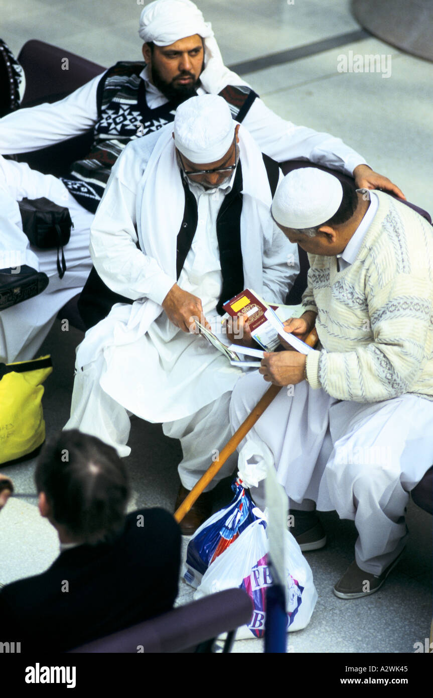 passengers waiting to travel to mecca at manchester airport Stock Photo