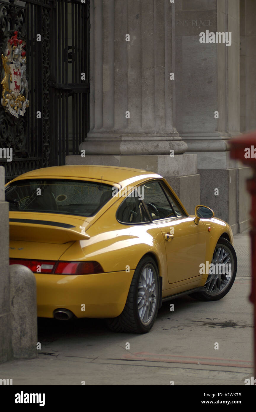 creative parking in the city of london yellow porche sports car parked between the columns in