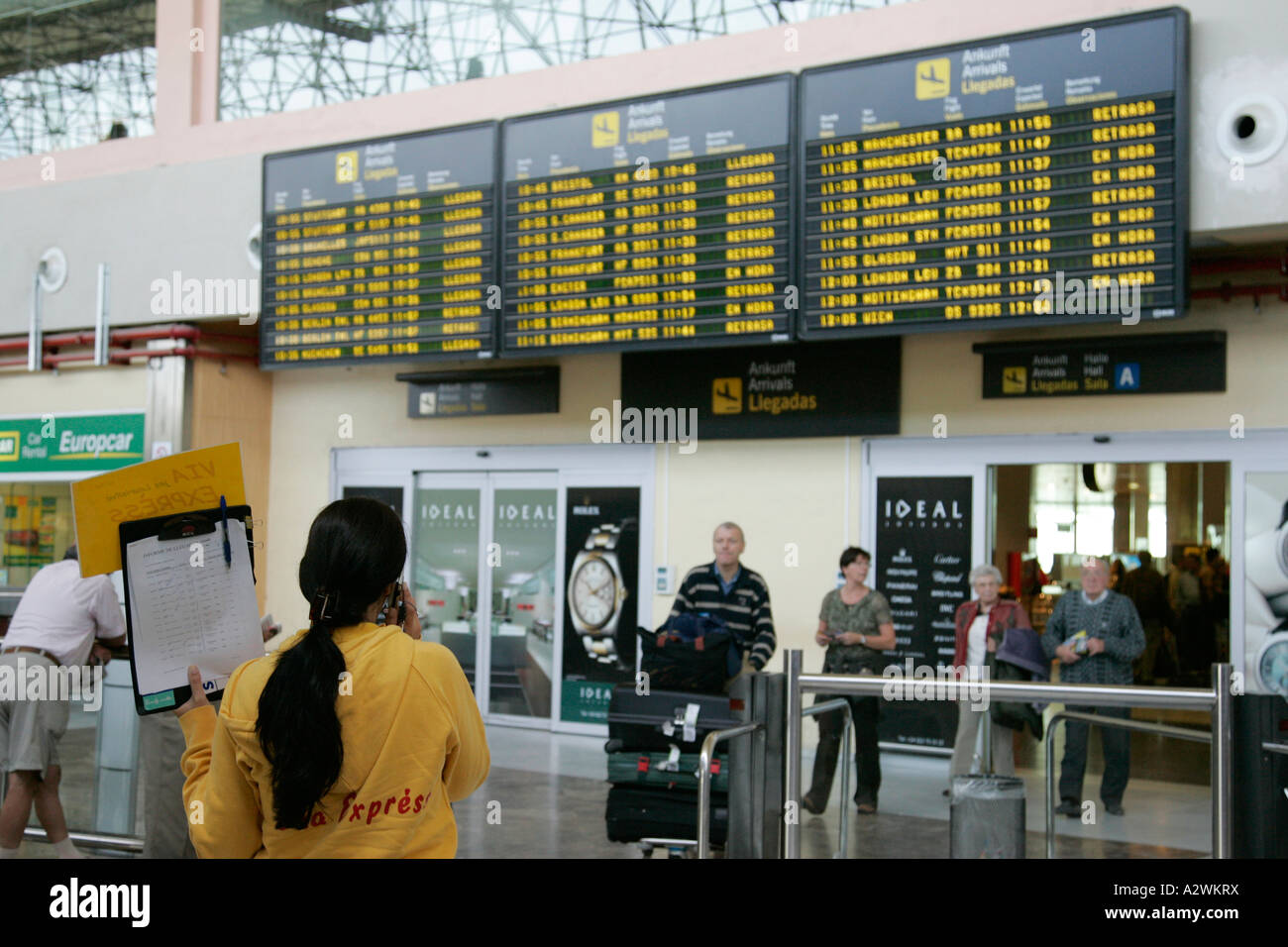spanish tour guide jobs Spanish female tour guide waits in front of arrivals message board.