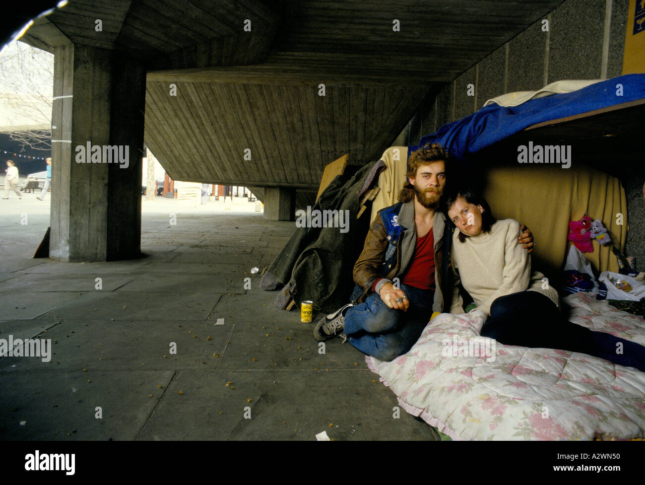 Young homeless couple in shelter under the Southbank complex, London