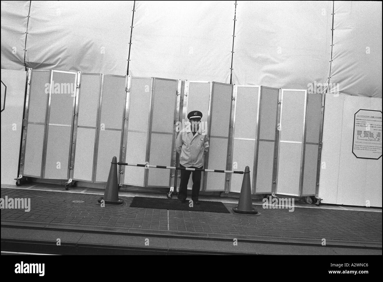 a security guard at the entrance to a building site in the upmarket district of Ginza, Tokyo, Japan, Asia Stock Photo