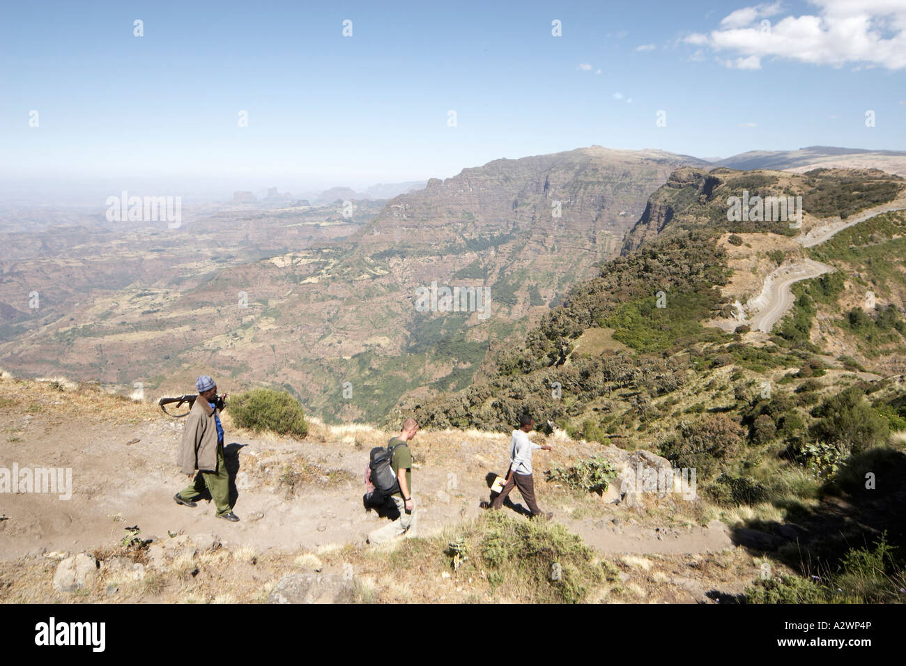People walking along escarpment cliffs in Simien Mountains National ...