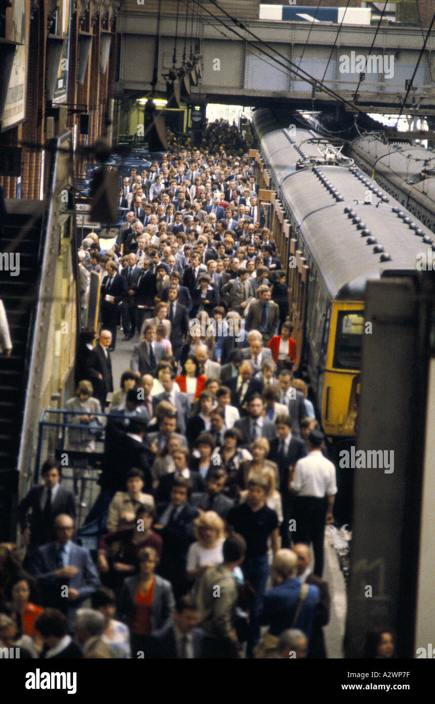 Rail commuters in London pouring down the platform Stock Photo