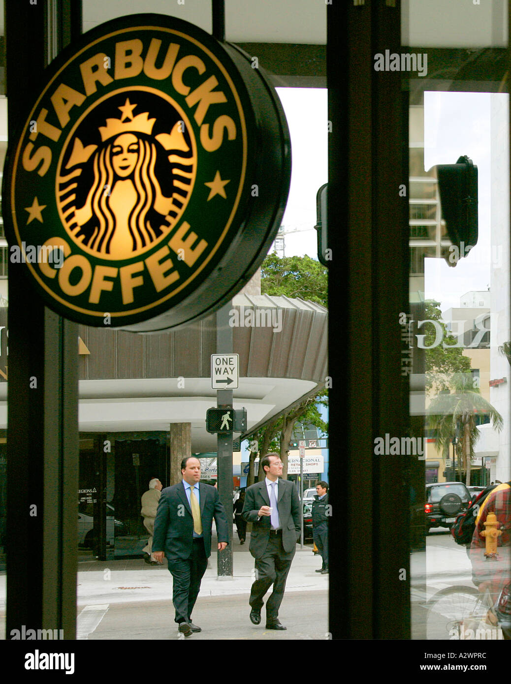 Starbucks Coffee sign in Miami Downtown cross pedestrian business men people street boulevard