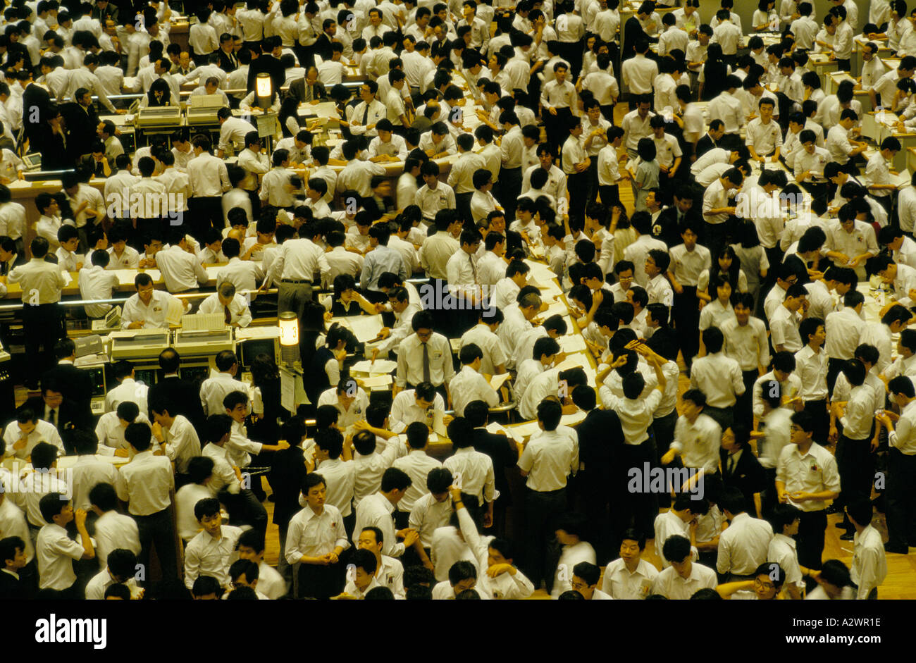 tokyo japan crowd of men at work on the trading floor of the japanese stock market Stock Photo