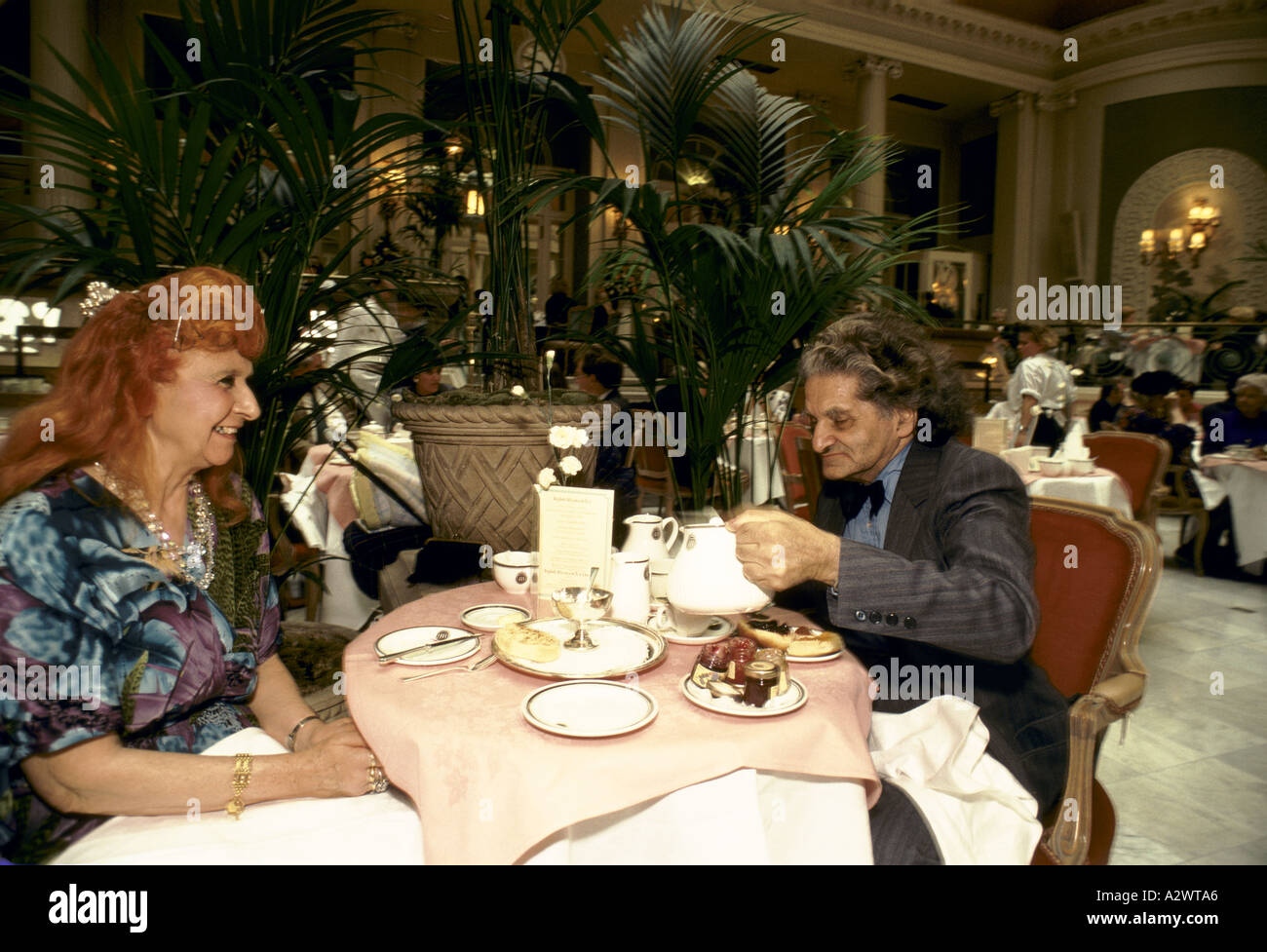 elderly couple having tea scones tea dance at the waldorf hotel london