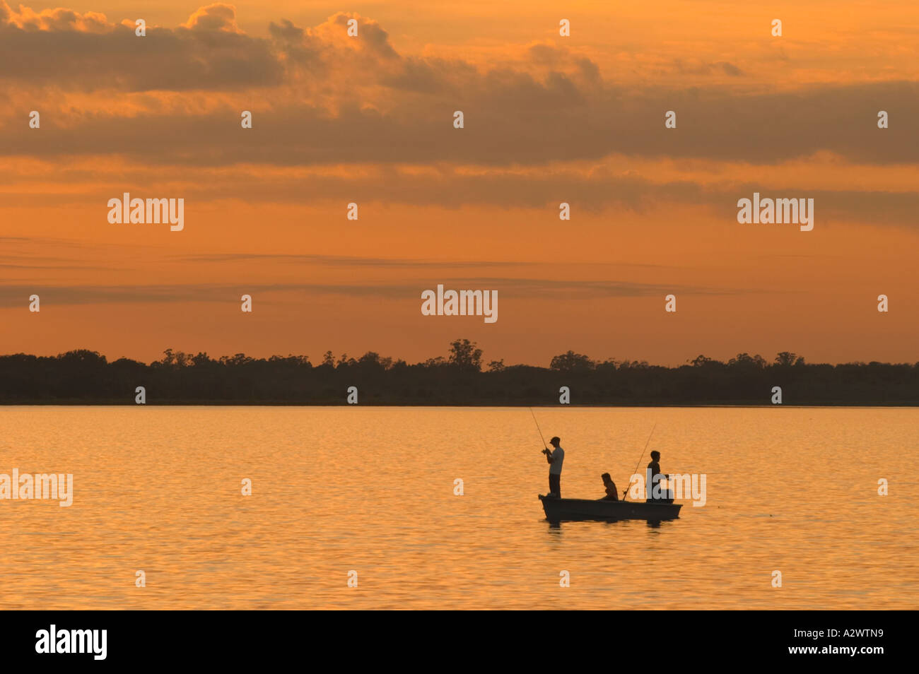 FISHING AT SUNSET IN UPPER MYAKKA LAKE IN MYAKKA RIVER STATE PARK FLORIDA Stock Photo