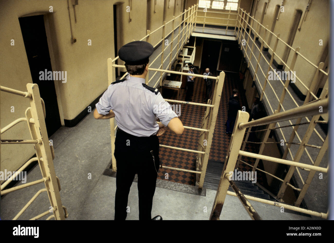 A warden watches over prisoners at Saughton prison, Scotland Stock Photo