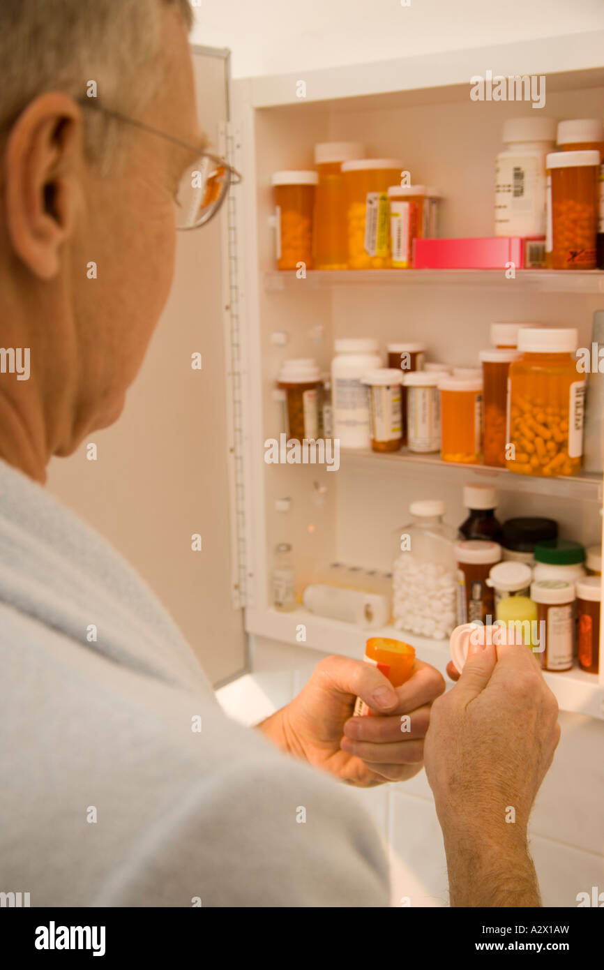 Medicine cabinet with pill bottles and syringe Stock Photo - Alamy