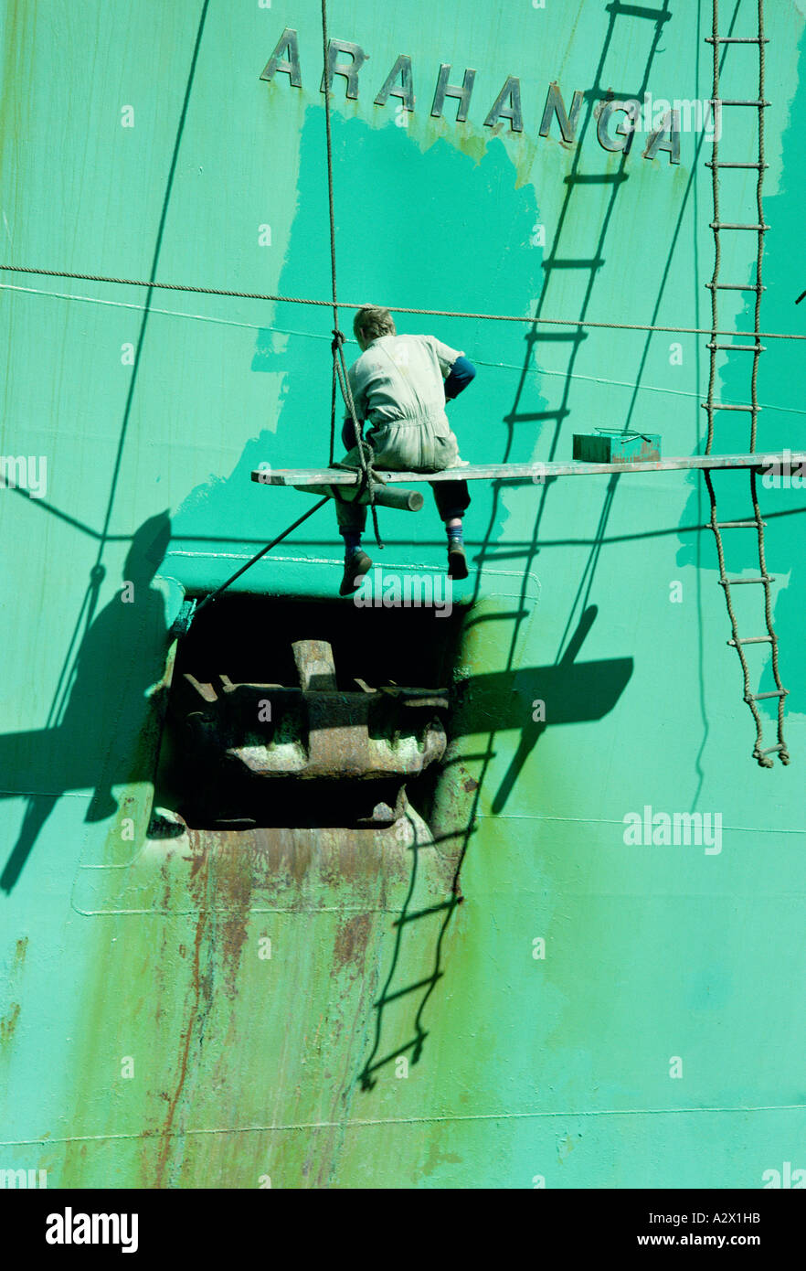 New Zealand. Wellington. Man painting ship's hull Stock Photo Alamy