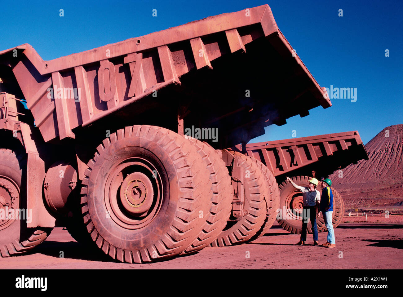Western Australia.Tom Price Mine. Two men observing huge iron ore truck Stock Photo Alamy