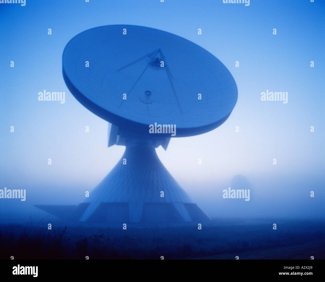 Germany. Munich. Satellite communications aerial tracking dish in misty morning light. Stock Photo