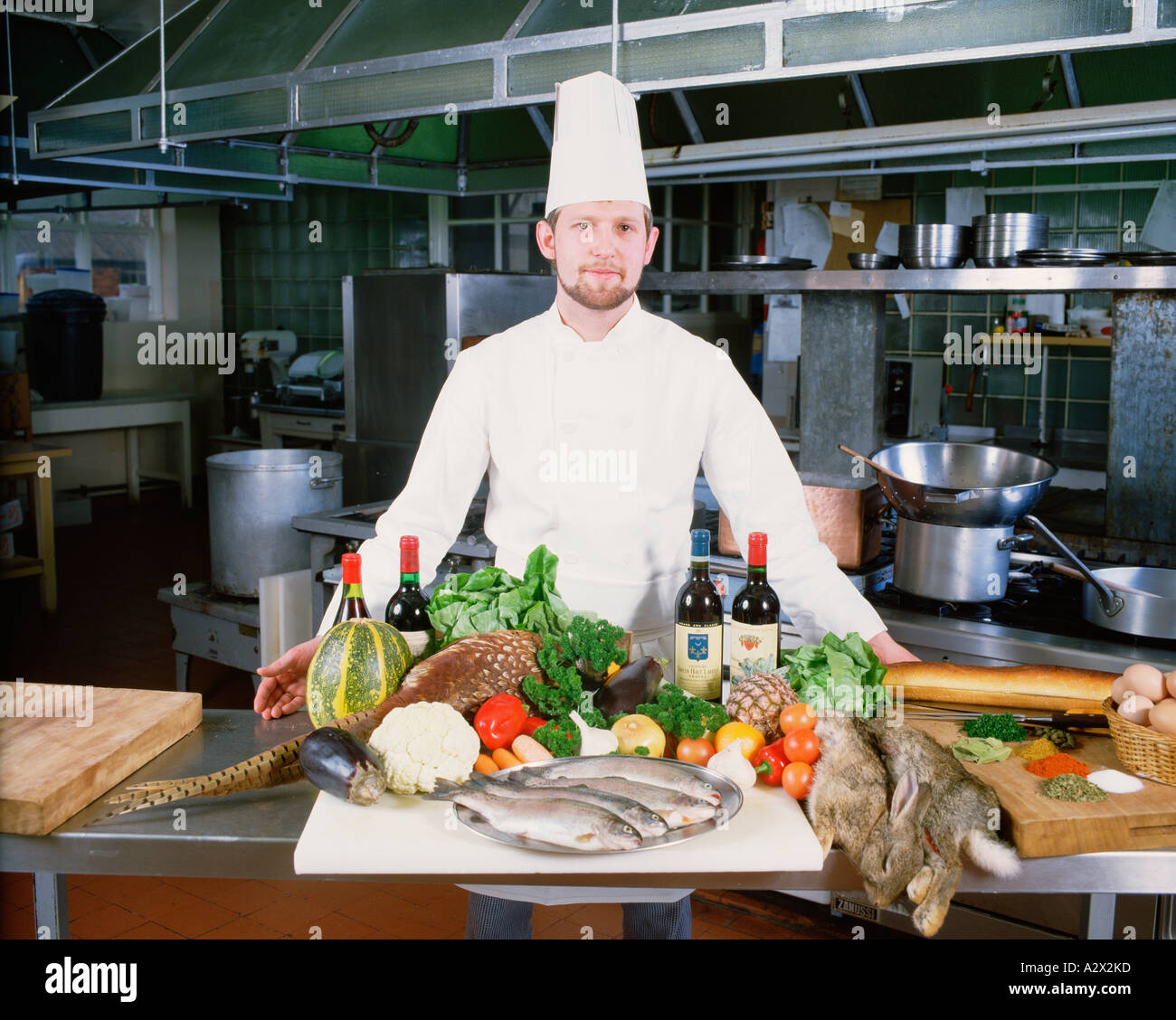 Professional Chef in Hotel Kitchen with display of fresh local produce. Stock Photo