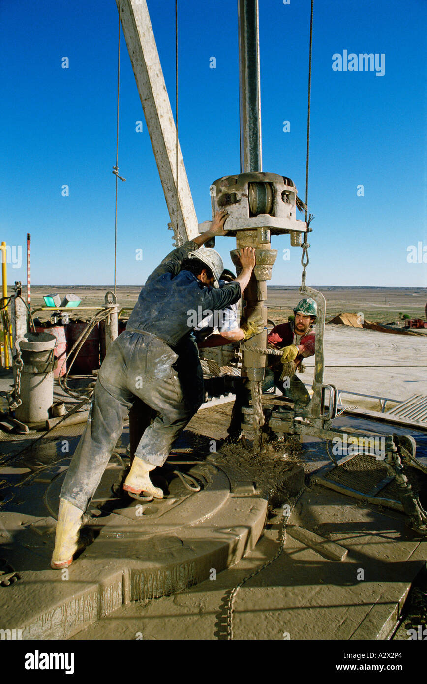 Australia. Industry. Oil extraction. Men operating drill at desert oil