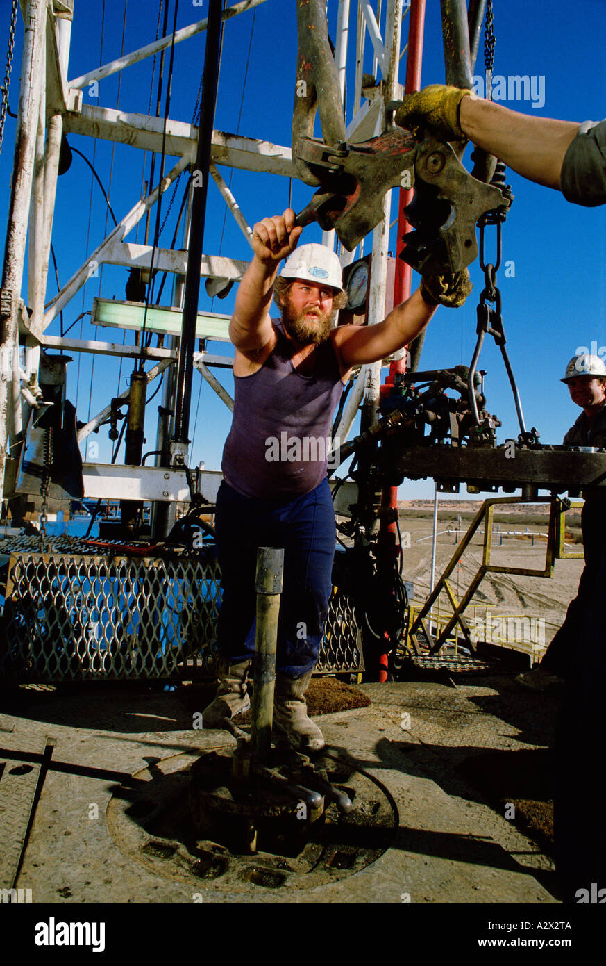 Australia. Cooper Basin. Oil well workers positioning drill Stock Photo