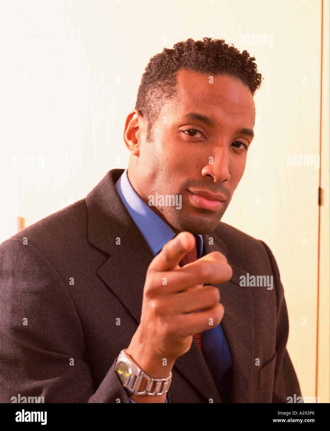 Portrait of young man in business suit. Pointing his finger. Stock Photo