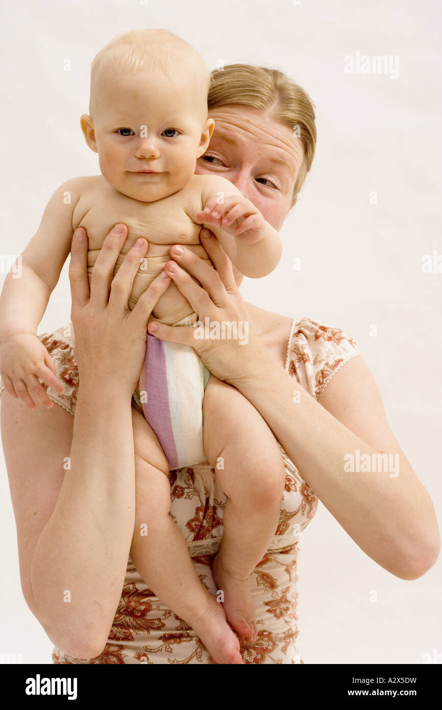 Mother holding her 8 month old baby girl. Stock Photo