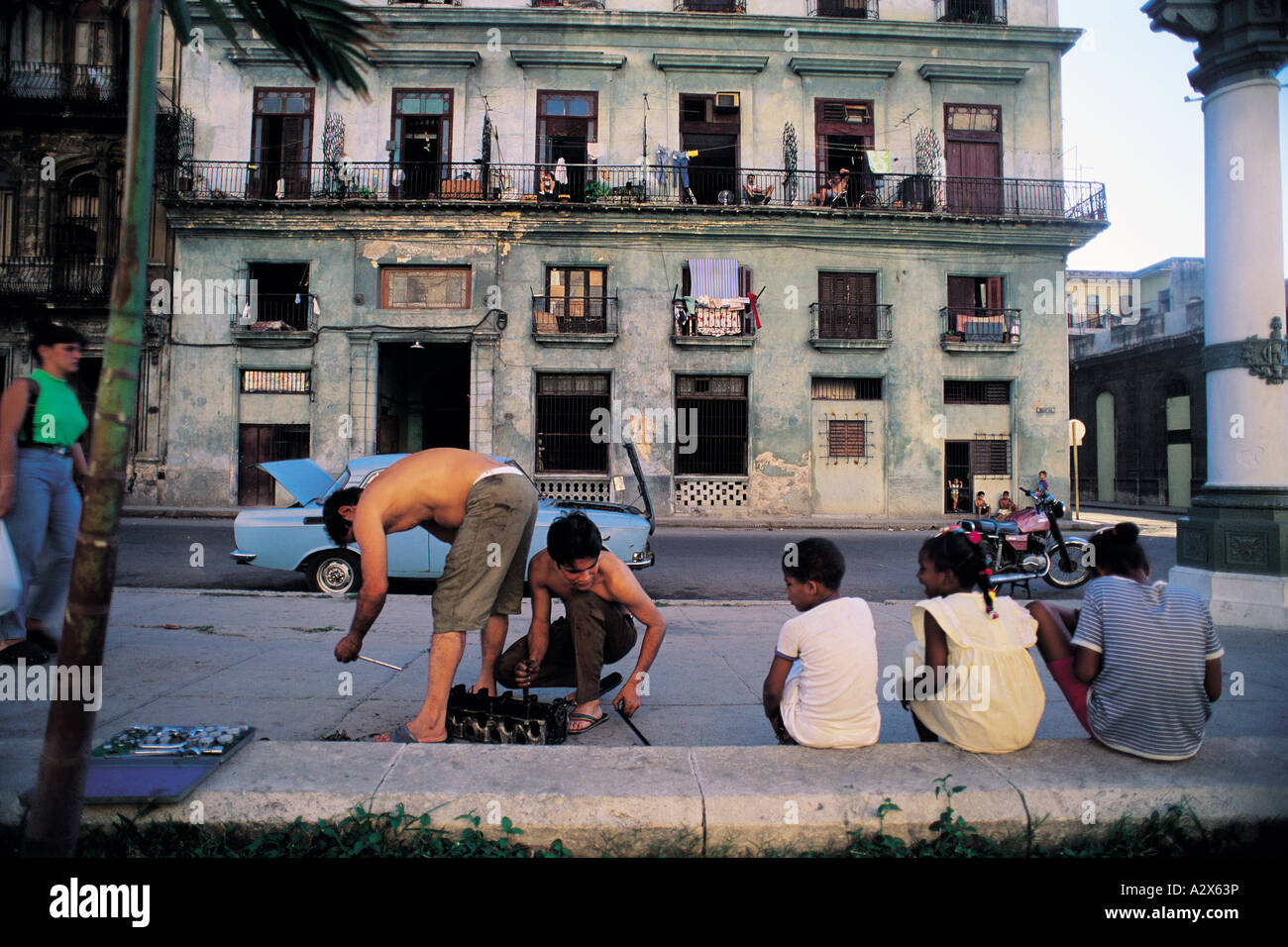 Teenagers fixing a car engine in a street Havana Cuba. Stock Photo