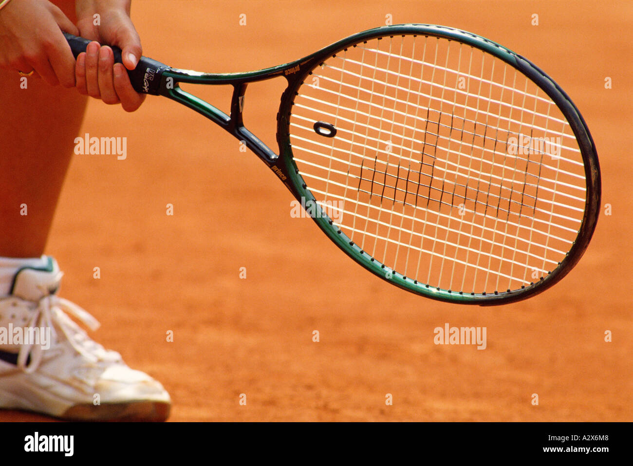 Close-up of female tennis player's foot and racket on hard court. Stock Photo