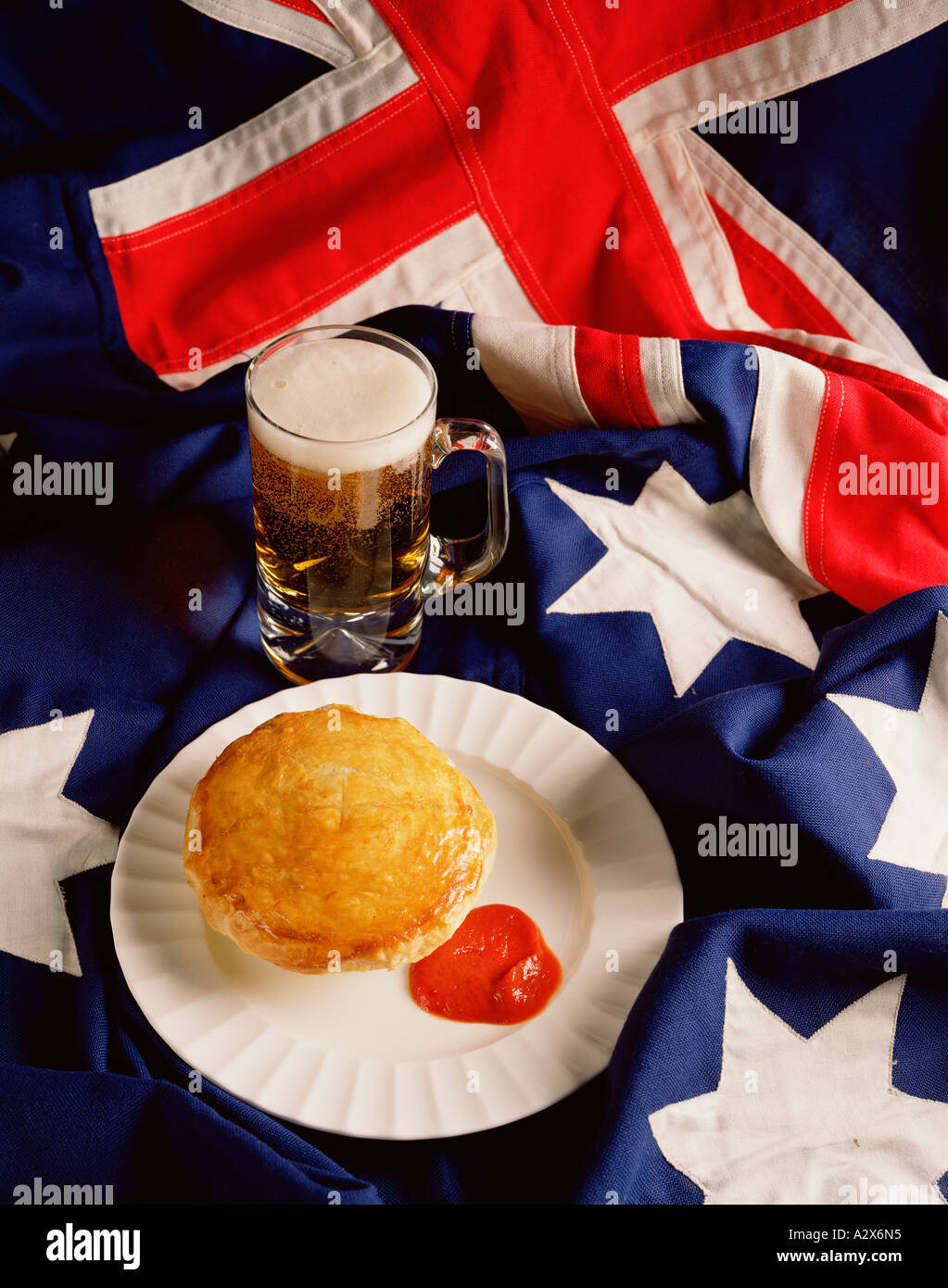 Studio food still life. Traditional Australian meat pie and ketchup with a  glass of beer.takeout Stock Photo - Alamy