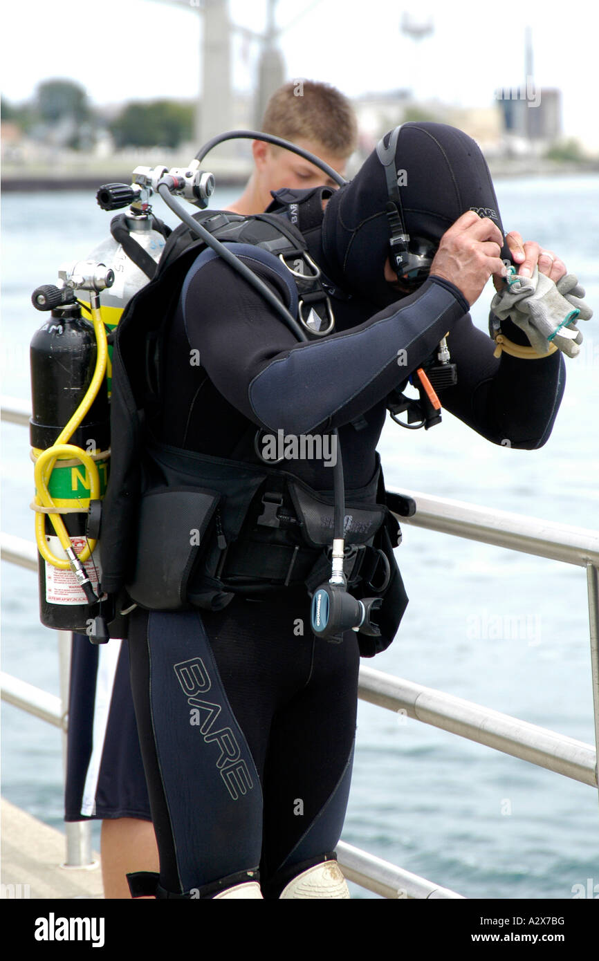 Adult male preparing to go cold water scuba diving Stock Photo Alamy