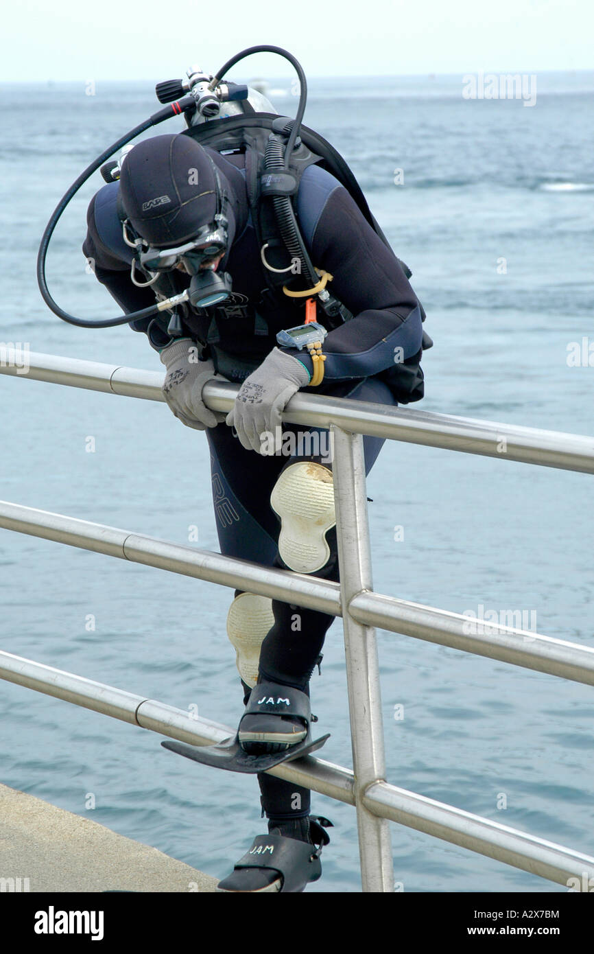 Adult male preparing to go cold water scuba diving Stock Photo Alamy