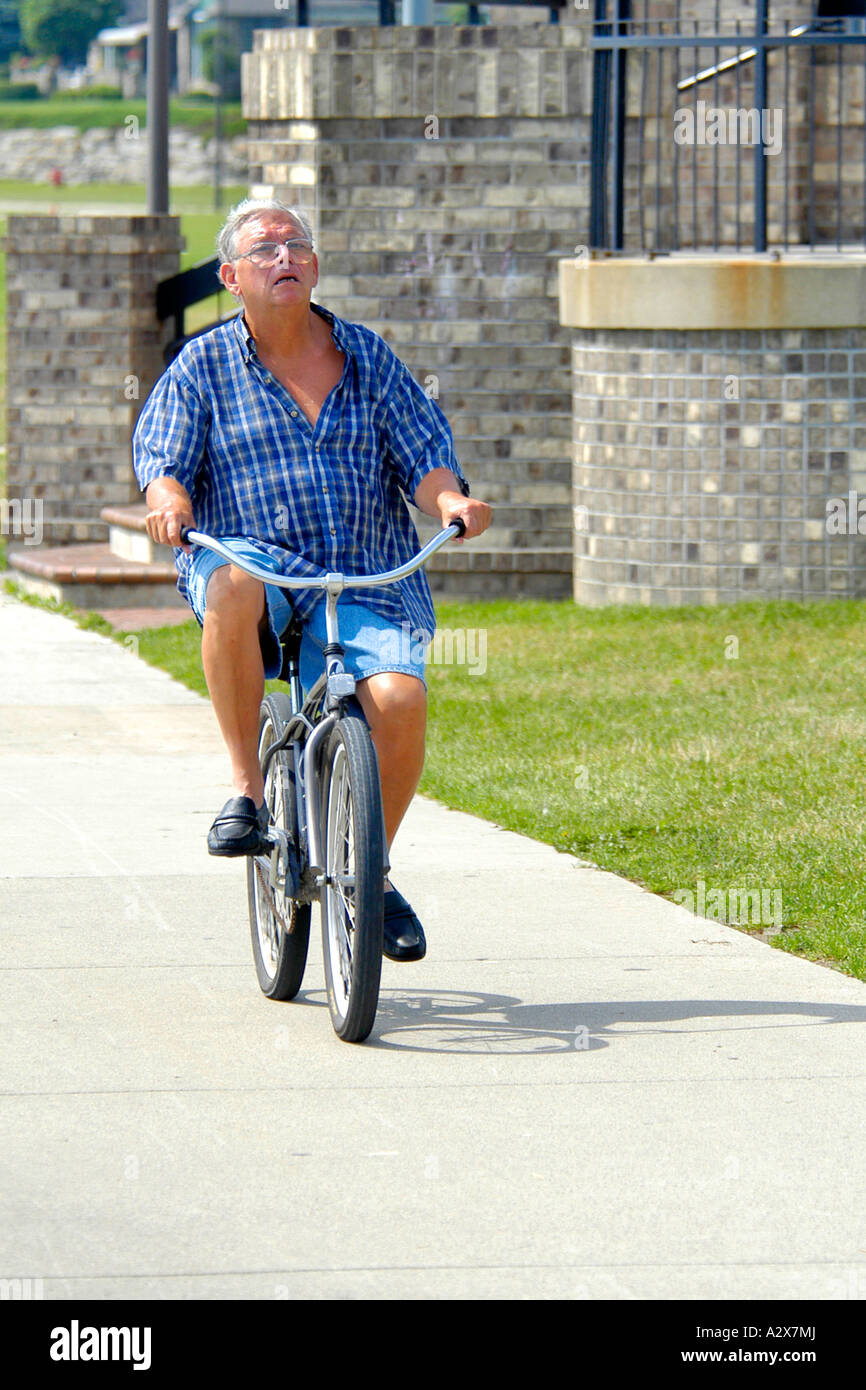 Man riding a bicycle without wearing a helmet Stock Photo Alamy