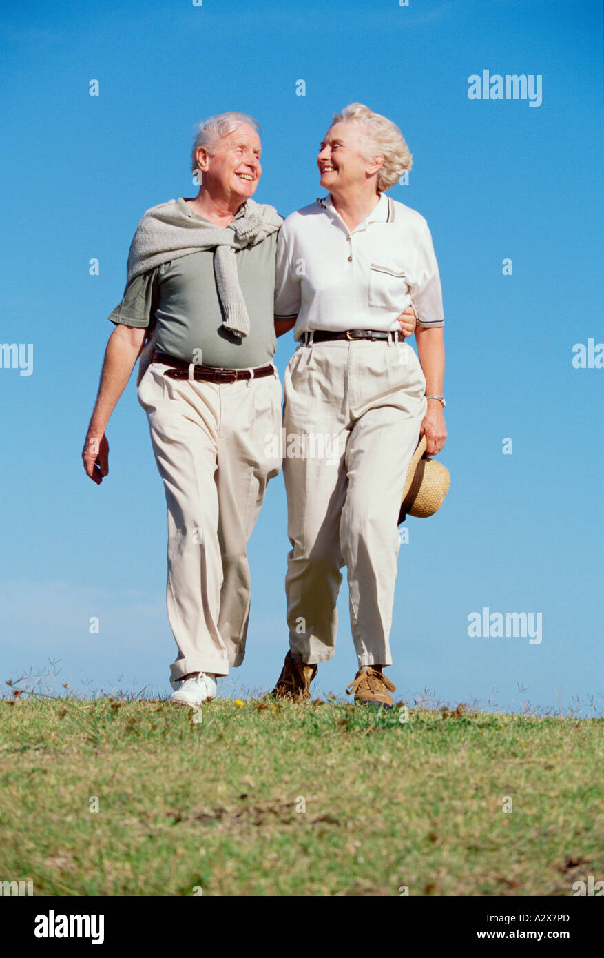Retired couple walking outdoors. Stock Photo
