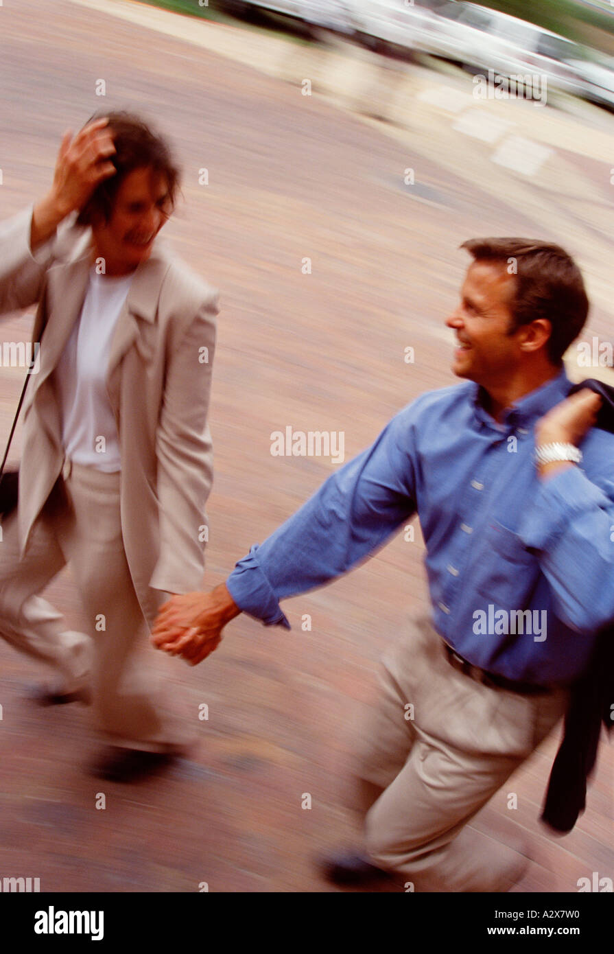 Young man and woman walking together in outdoor urban street Stock ...