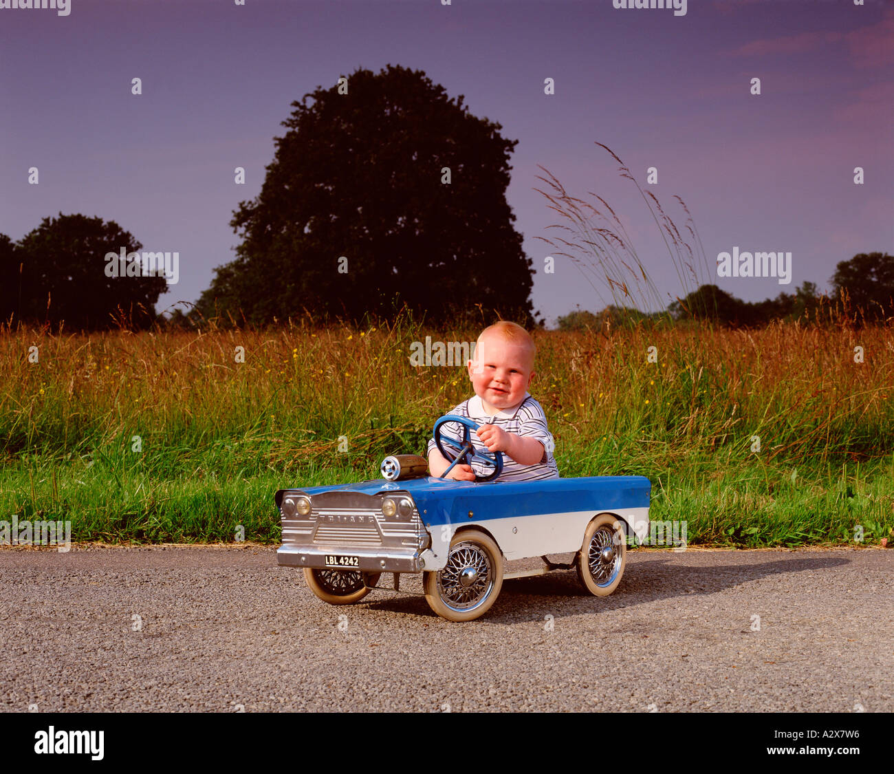Little boy child outdoors driving pedal car Stock Photo Alamy